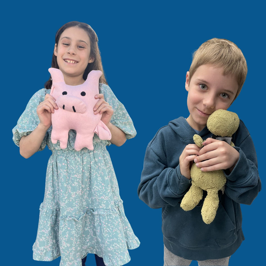 Kids working on stuffed animal sewing projects at Unfold Den in Denver