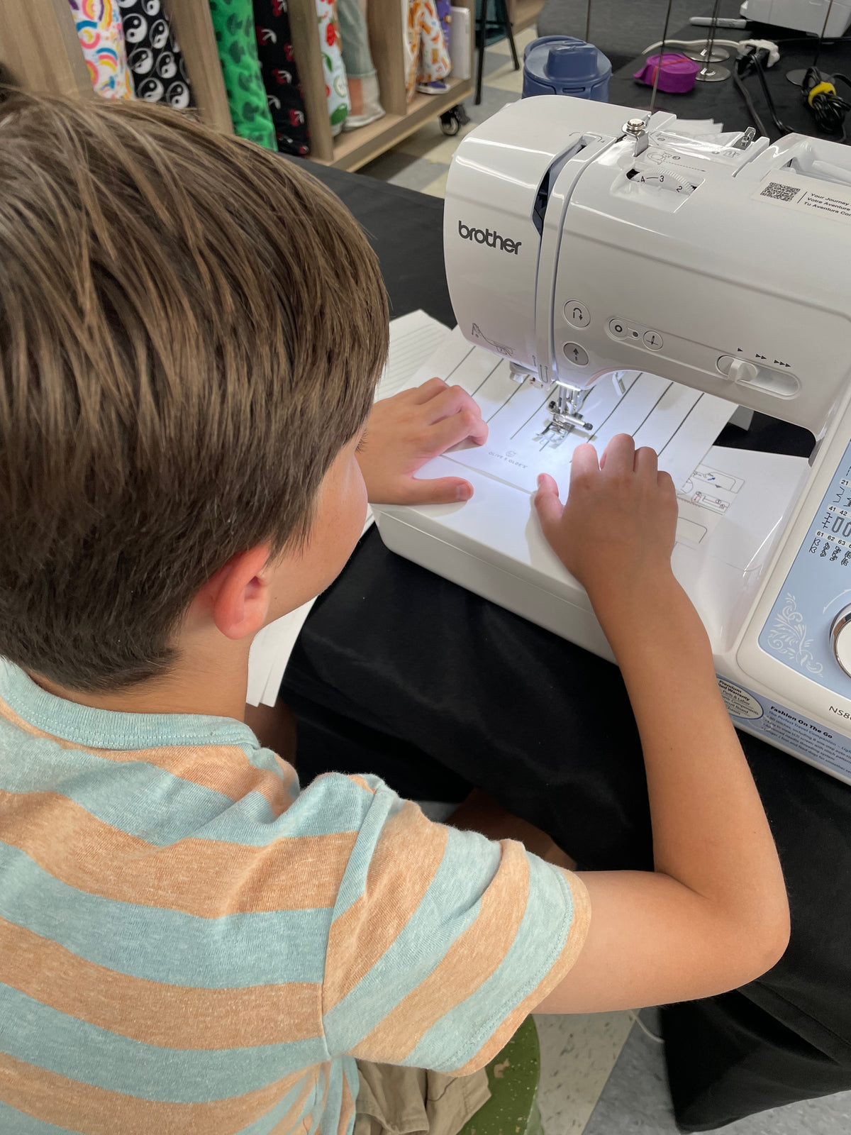 Students sewing together at Unfold Den's Denver sewing studio
